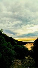 Scenic view of landscape against cloudy sky