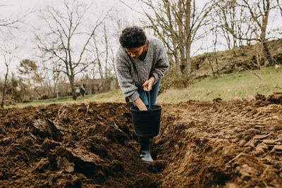 Woman sowing potatoes in portugal