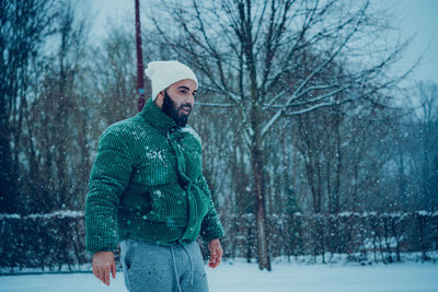 Portrait of man standing on snow