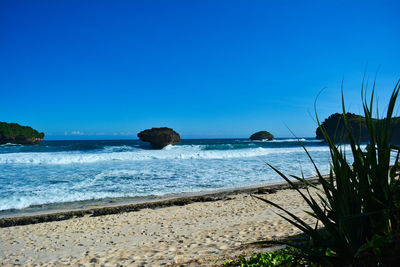 Scenic view of sea against clear blue sky