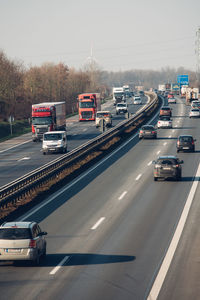 Vehicles on highway against sky