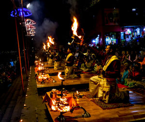 People at illuminated temple during night