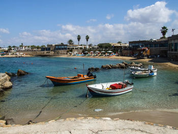 Boats moored on sea at caesarea maritima