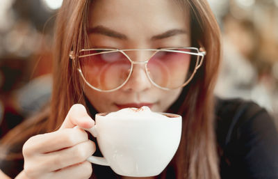 Close-up portrait of a woman drinking drink