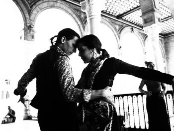 Couple standing against wall