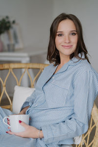 Portrait of smiling young woman using mobile phone