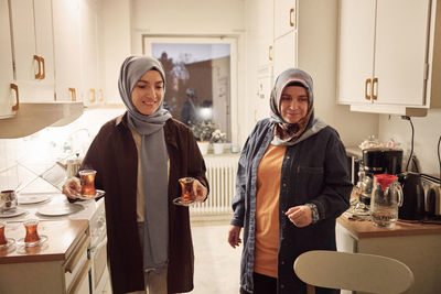 Women preparing evening tea at home