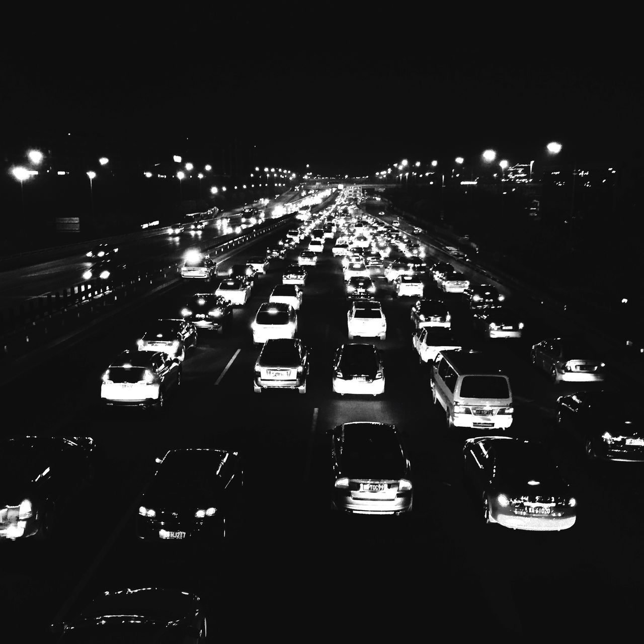 night, illuminated, transportation, city, mode of transport, high angle view, car, land vehicle, city life, street, street light, traffic, road, building exterior, city street, architecture, built structure, in a row, incidental people, outdoors