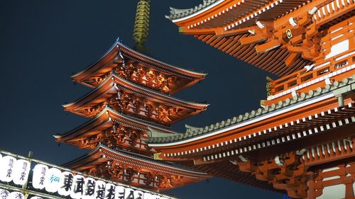 Low angle view of illuminated pagoda against sky