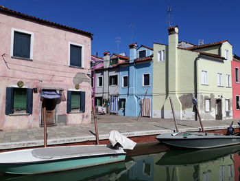 Pastel coloured buildings and boats.