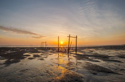 Scenic view of beach against sky during sunset