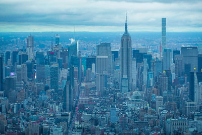 Aerial view of modern buildings in city against sky