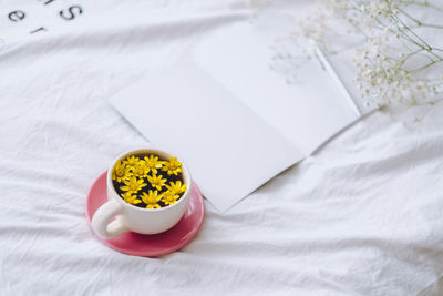 High angle view of yellow and white flower on bed