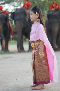 Rear view of girl with pink umbrella