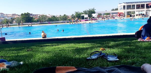 People by swimming pool in park