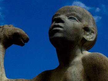 Low angle view of statue against clear blue sky