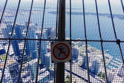 Sign on railing against the river