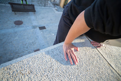 Midsection of man climbing on wall