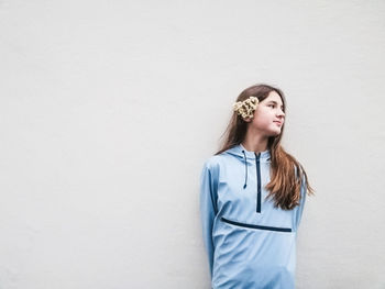 Young woman standing against white background