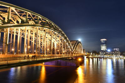 Low angle view of illuminated bridge at night