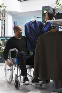 Rear view of man sitting on street