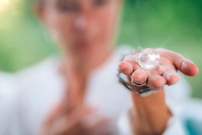 Mindful awareness. spiritually awakened person holding a crystal pearl, feeling connected