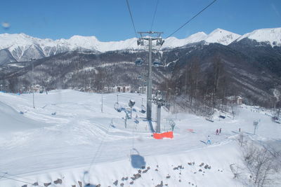 Ski lift over snow covered mountains