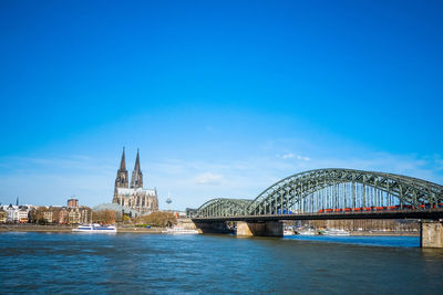 Bridge over river against buildings