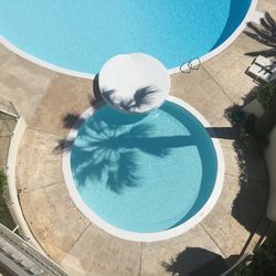 High angle view of swimming pool against blue sky