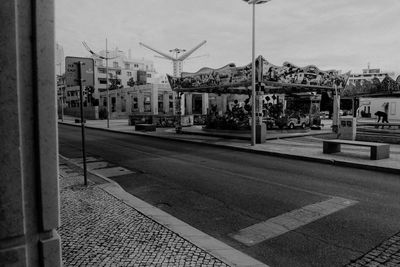 City street by buildings against sky