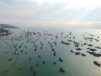 High angle view of crowd in sea against sky