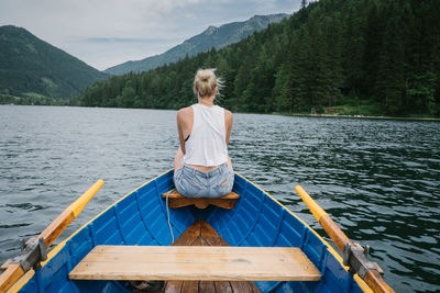 Woman sitting on boat in lake