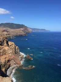 Scenic view of sea against blue sky