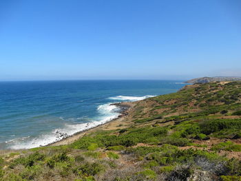 Scenic view of sea against clear blue sky