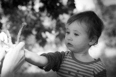 Cropped hand giving stick to cute boy