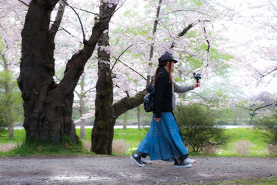 Woman holding umbrella in forest