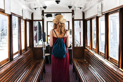 Rear view of woman standing in vehicle