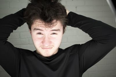 Portrait of young man against wall