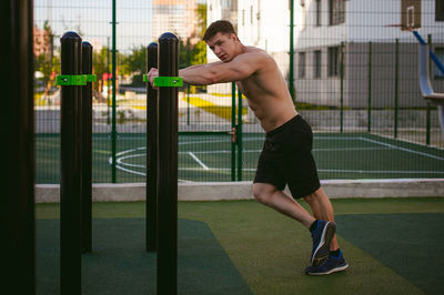 Muscular man exercising at park