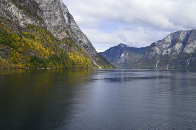 Scenic view of lake and mountains against sky