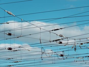 Low angle view of cables against blue sky