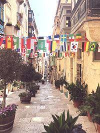 Footpath amidst buildings in city