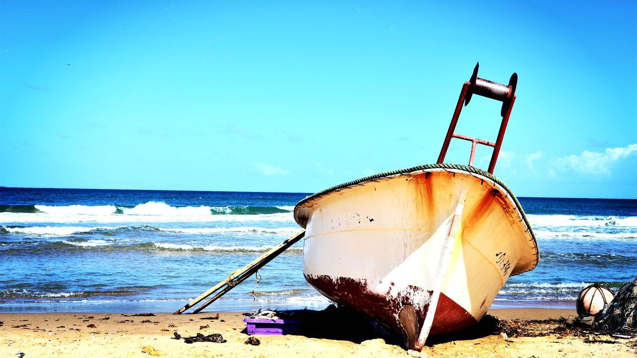 sea, beach, water, horizon over water, clear sky, shore, blue, sand, nautical vessel, abandoned, boat, moored, tranquility, tranquil scene, transportation, sunlight, copy space, sky, nature, scenics