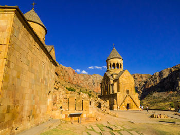 Low angle view of historic building against clear blue sky