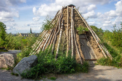 Wooden structure amidst plants and trees against sky