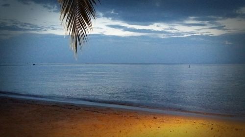 Scenic view of sea against cloudy sky