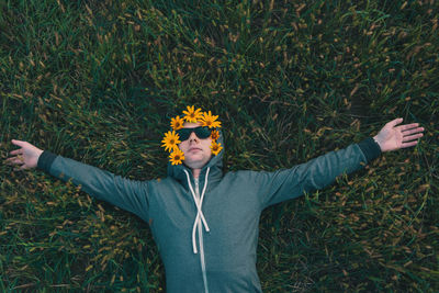 Portrait of young man wearing sunglasses while standing against plants