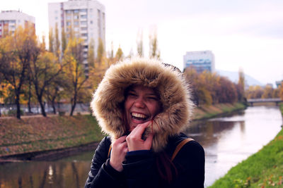 Portrait of smiling young woman in lake