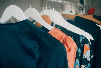 Close-up of clothes hanging on rack in store