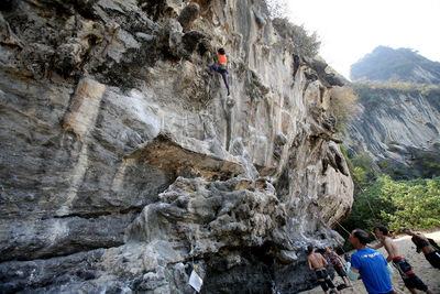 People on rock with mountain in background